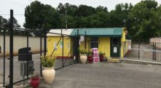 The exterior of the Mid-South Self Storage facility office and secure access gate.