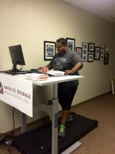 ASM employee working at a treadmill desk.