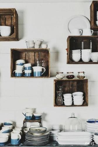 Wooden crates hanging on a kitchen wall.