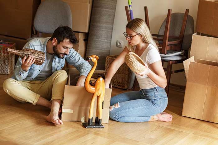 A modern couple packing boxes in their apartment.