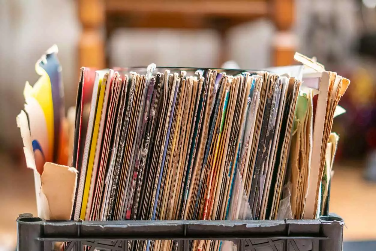 a stack of documents sits in a plastic crate