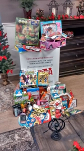 Toys for Tots bin surrounded by toys.