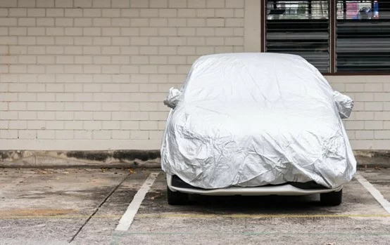 A car wrapped up in a vehicle storage parking lot.