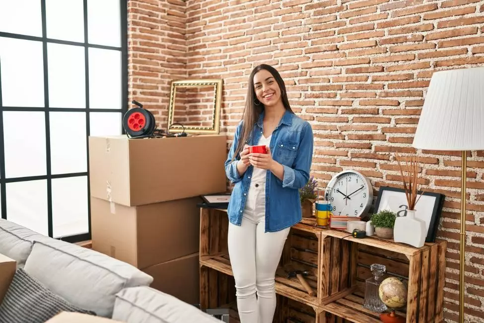 A woman standing in a studio apartment