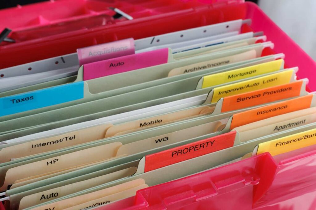 Household and personal documents organized in a colorful accordion file.