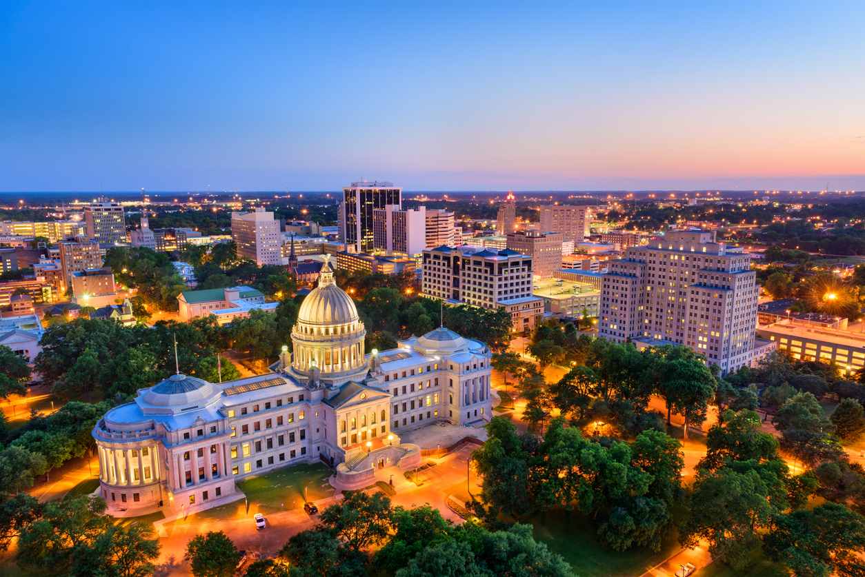 A sky view of the Mississippi Capitol building in Jackson, MS, at dusk.