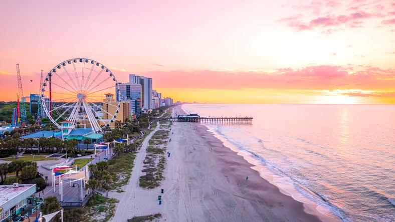 The beautiful beach and boardwalk at sunset in Myrtle Beach.