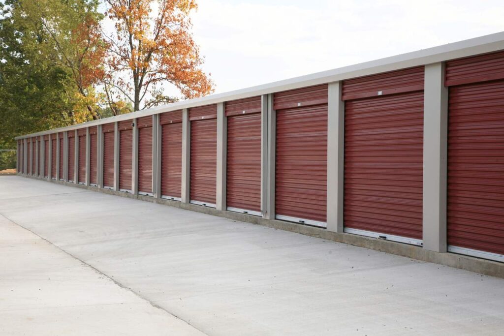 A row of self-storage units with red doors located at an automated self-storage facility.