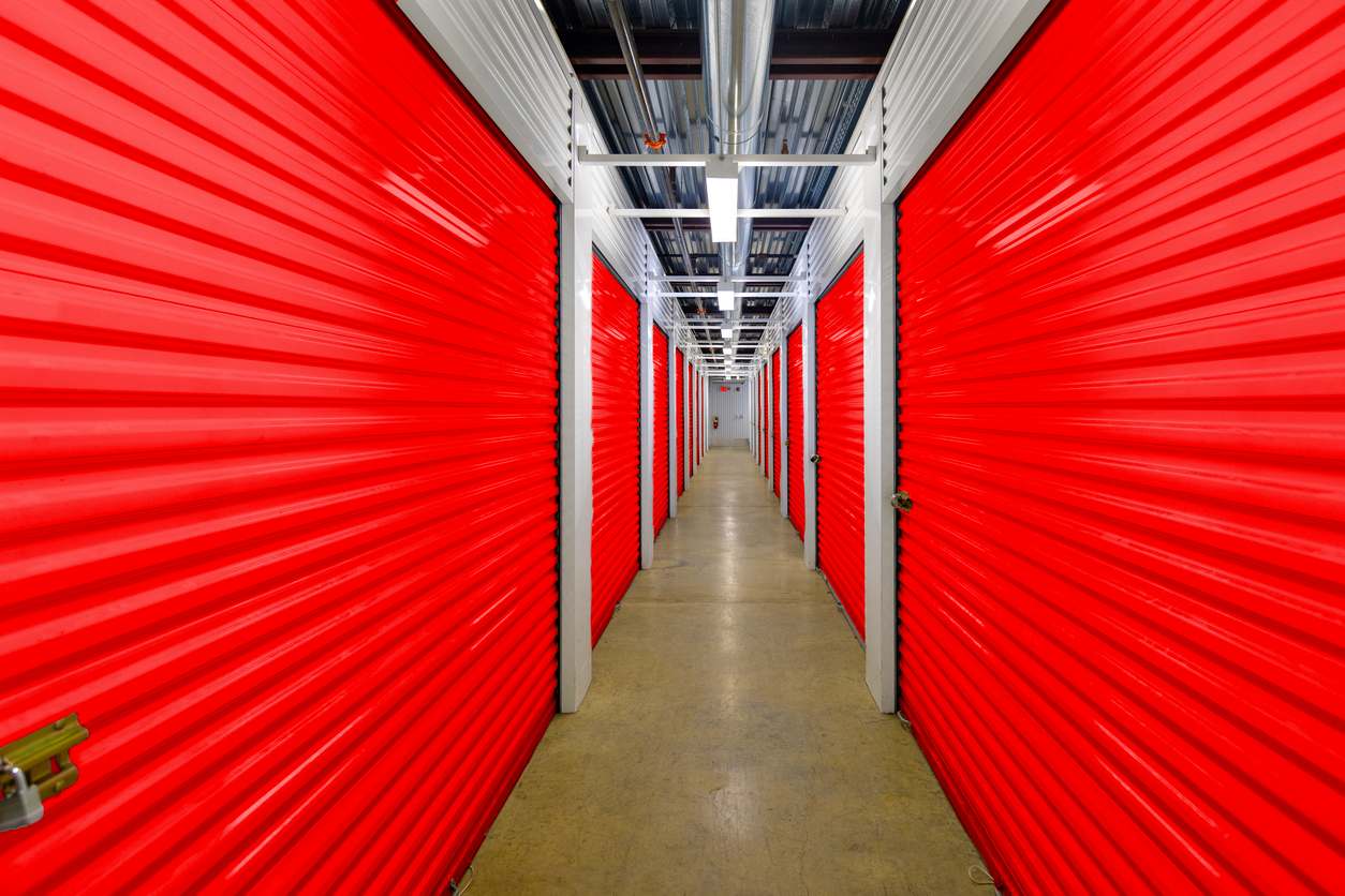 A hallway of a modern self-storage facility with secure storage unit doors.
